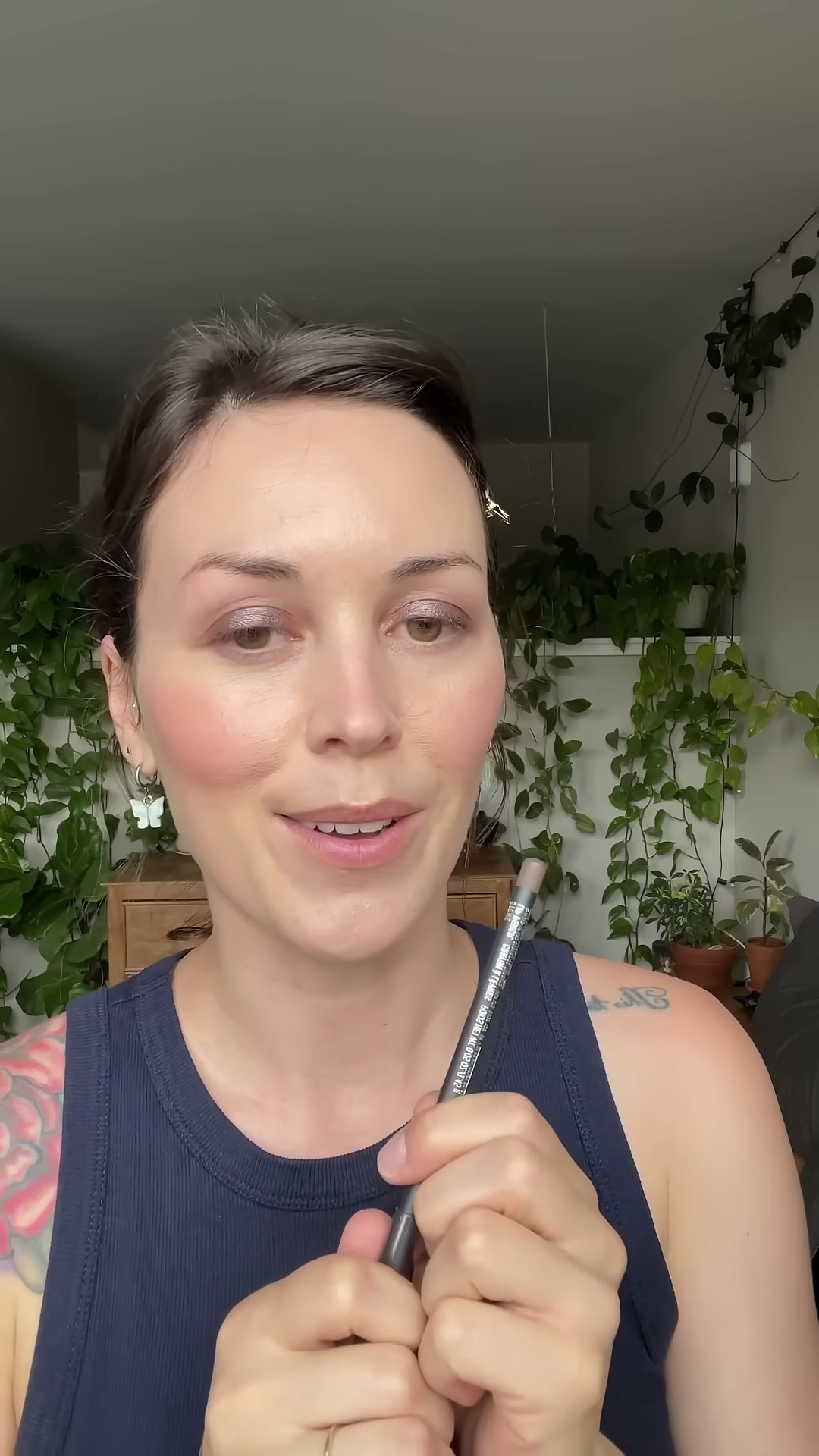 Creator applying MAC Stone lip liner to lips with careful precision