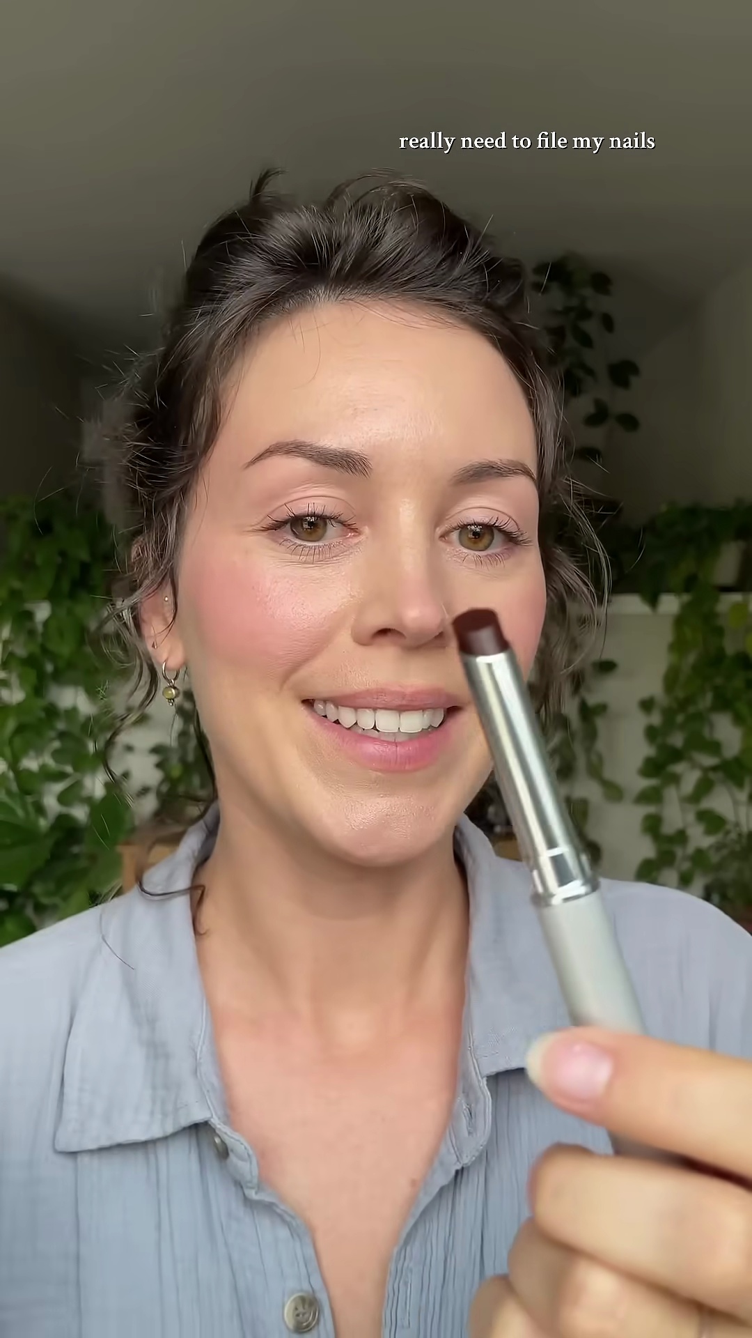 Close-up of Clinique Black Honey lipstick in Abby's hand