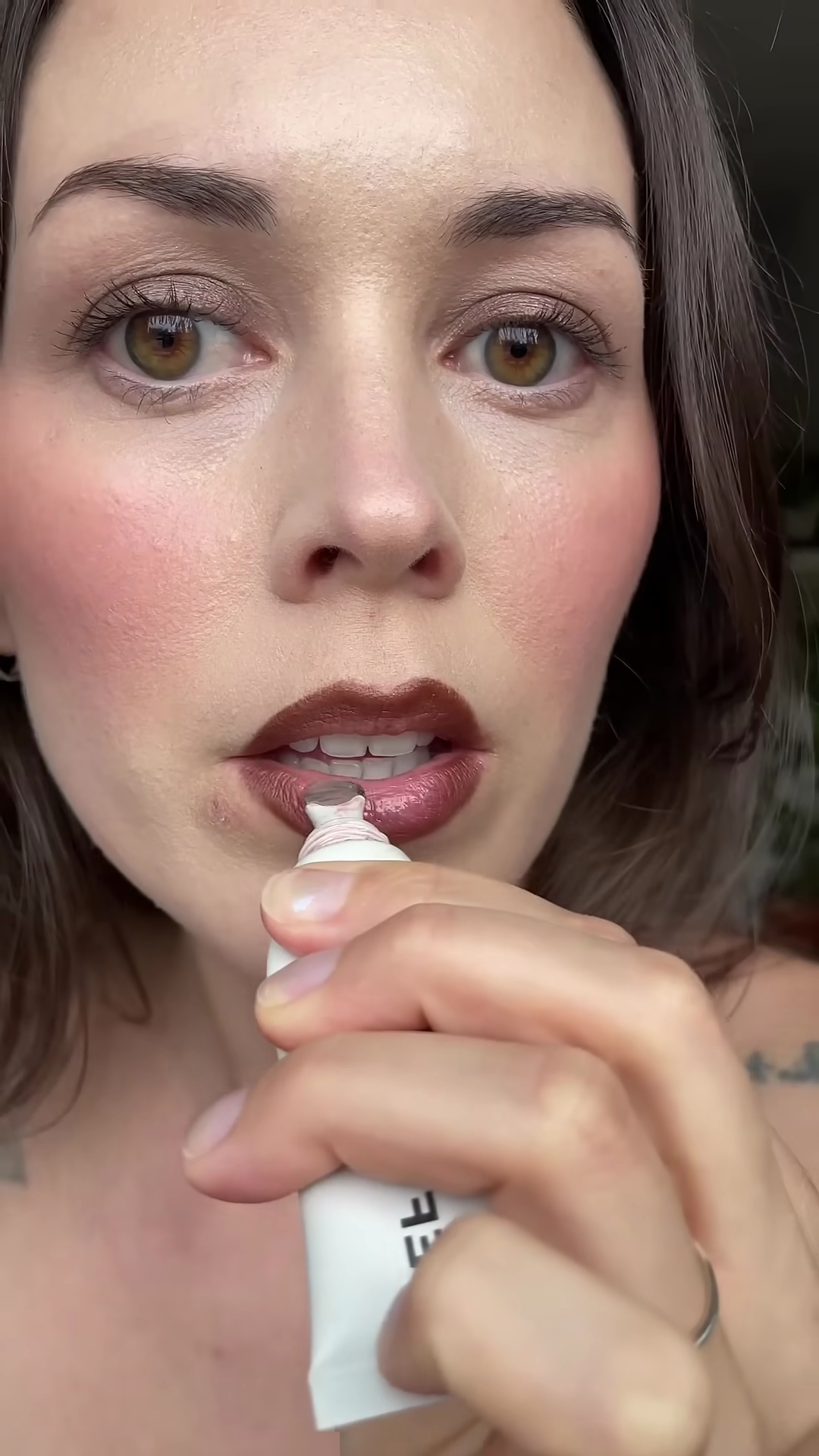 Applying clear lip gloss over Soshe Beauty Mocha lip pencil for glossy finish