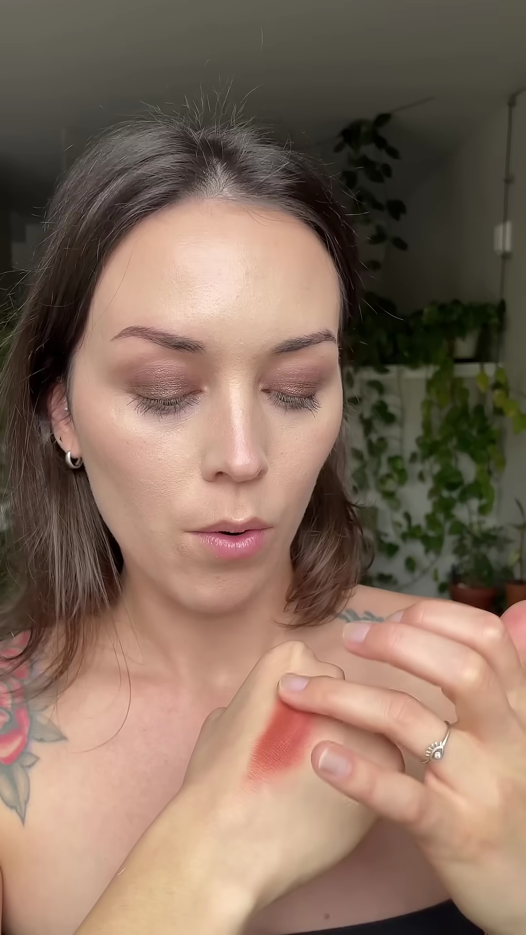 Applying Copper Spice blush lightly with brush on fair olive skin