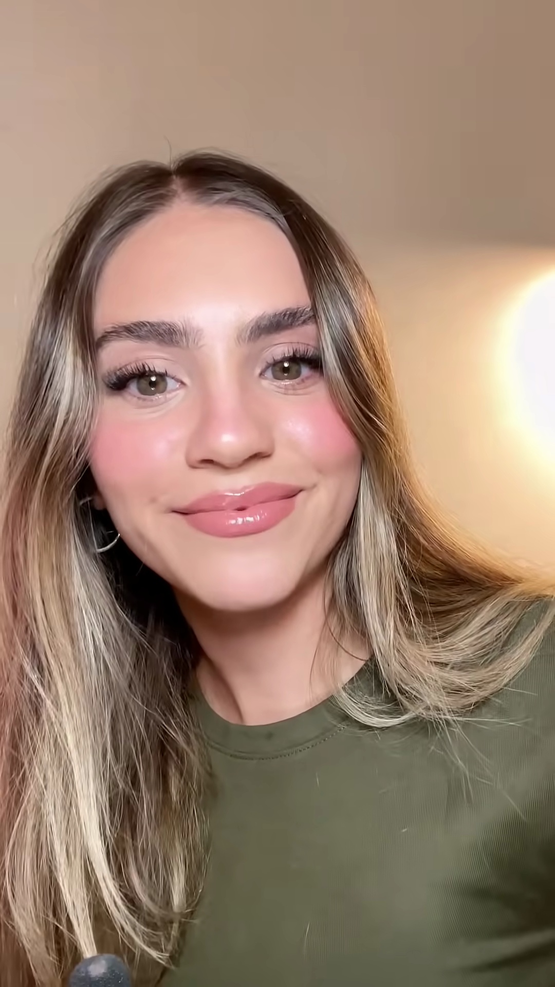 Creator smiling comfortably with plumped lips, showing no signs of irritation