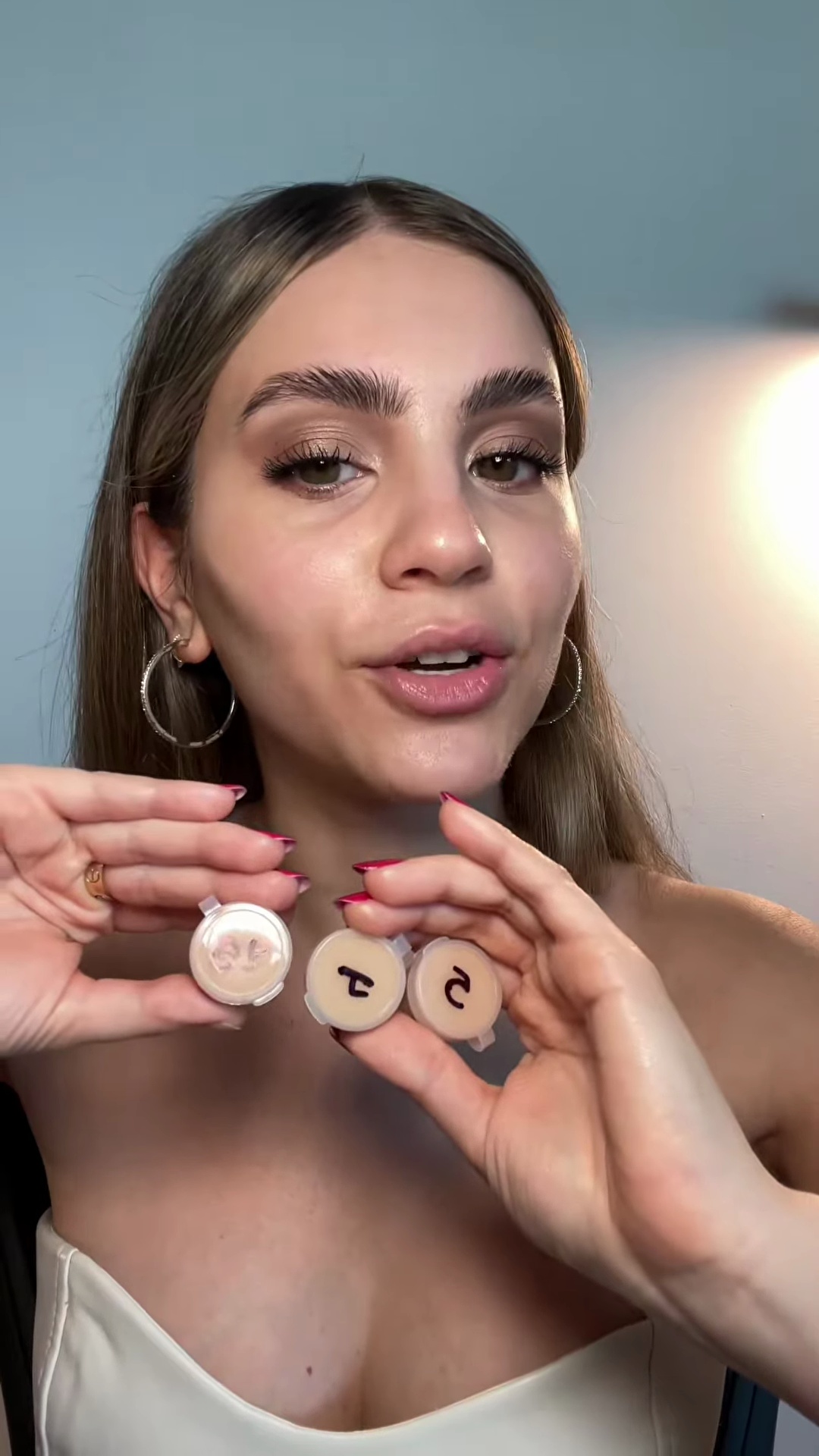 Three Armani Luminous Silk Foundation swatches on light olive skin arm