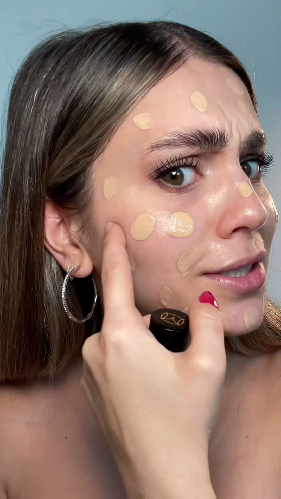 Bailey applying Armani Luminous Silk Foundation shade 5 to cheek