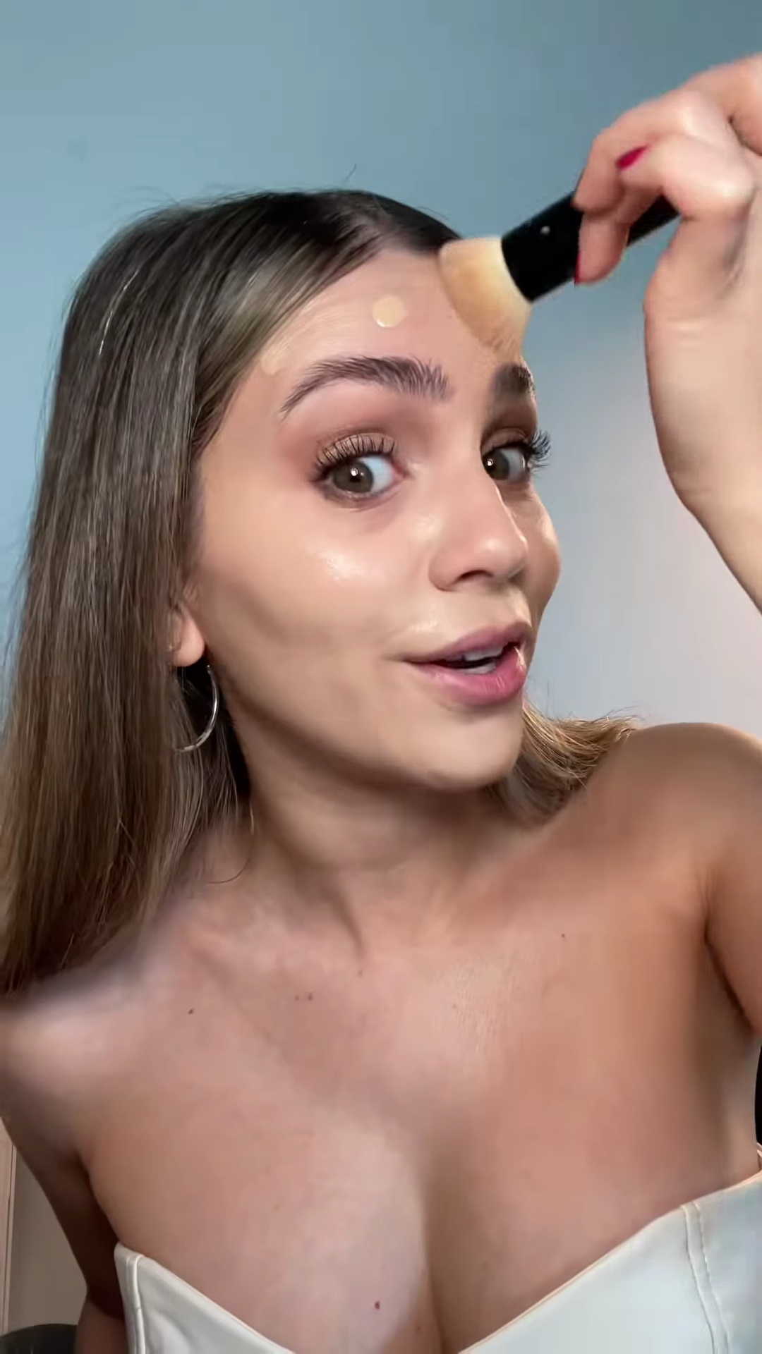 Bailey blending foundation from face down to neck for seamless transition