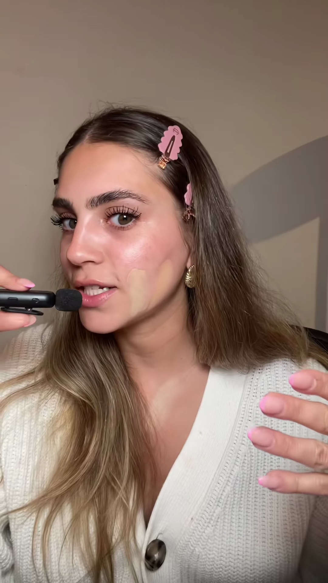 Close-up view of two foundation shades swatched on light olive skin for comparison