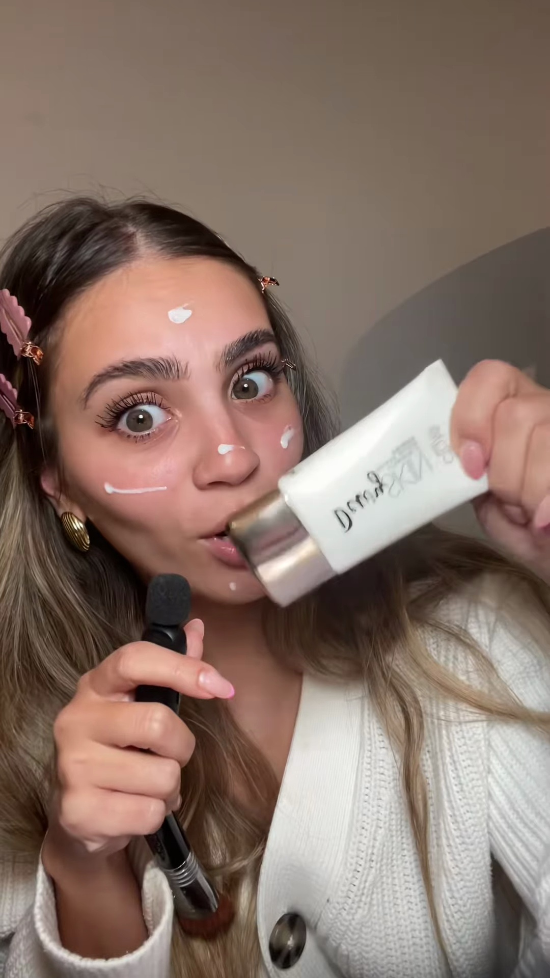 Creator applying foundation with beauty blender to half of face