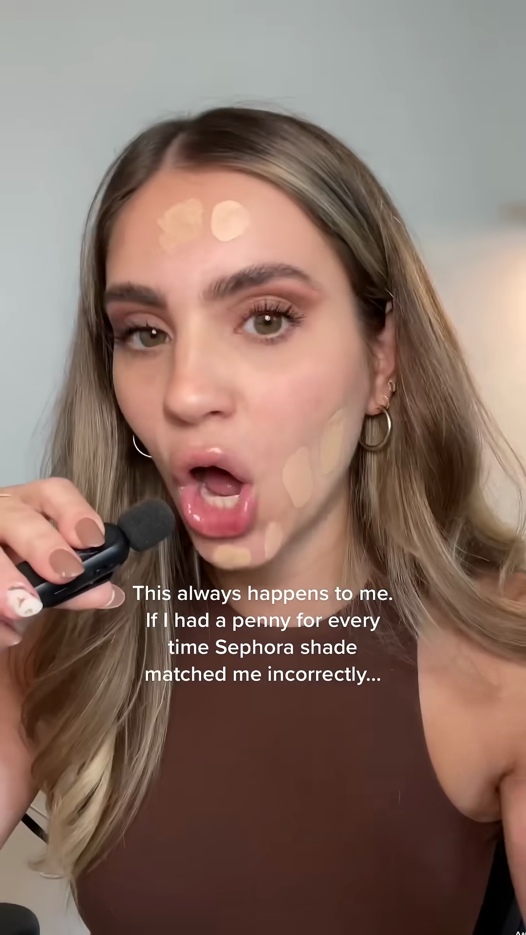 Beauty creator showing disappointment with foundation shade matching