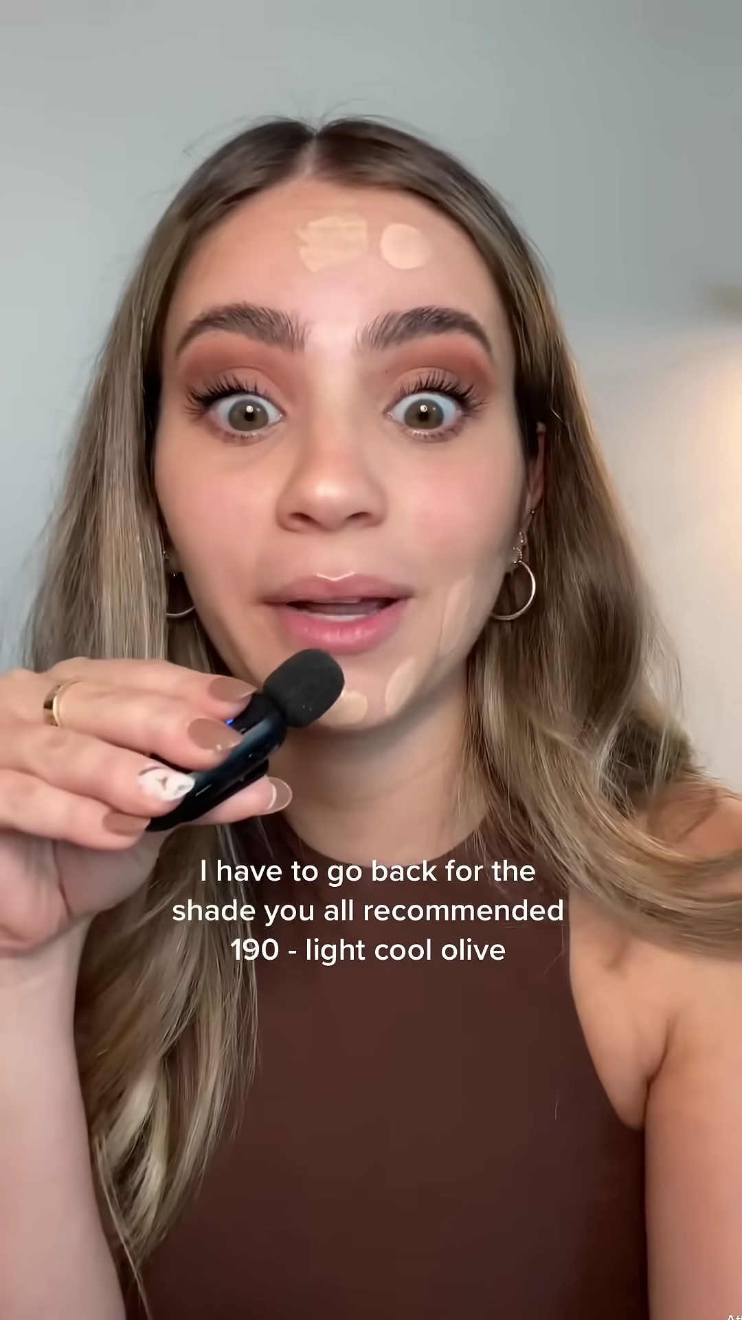 Half-face application of Haus Labs foundation shades 130 and 160