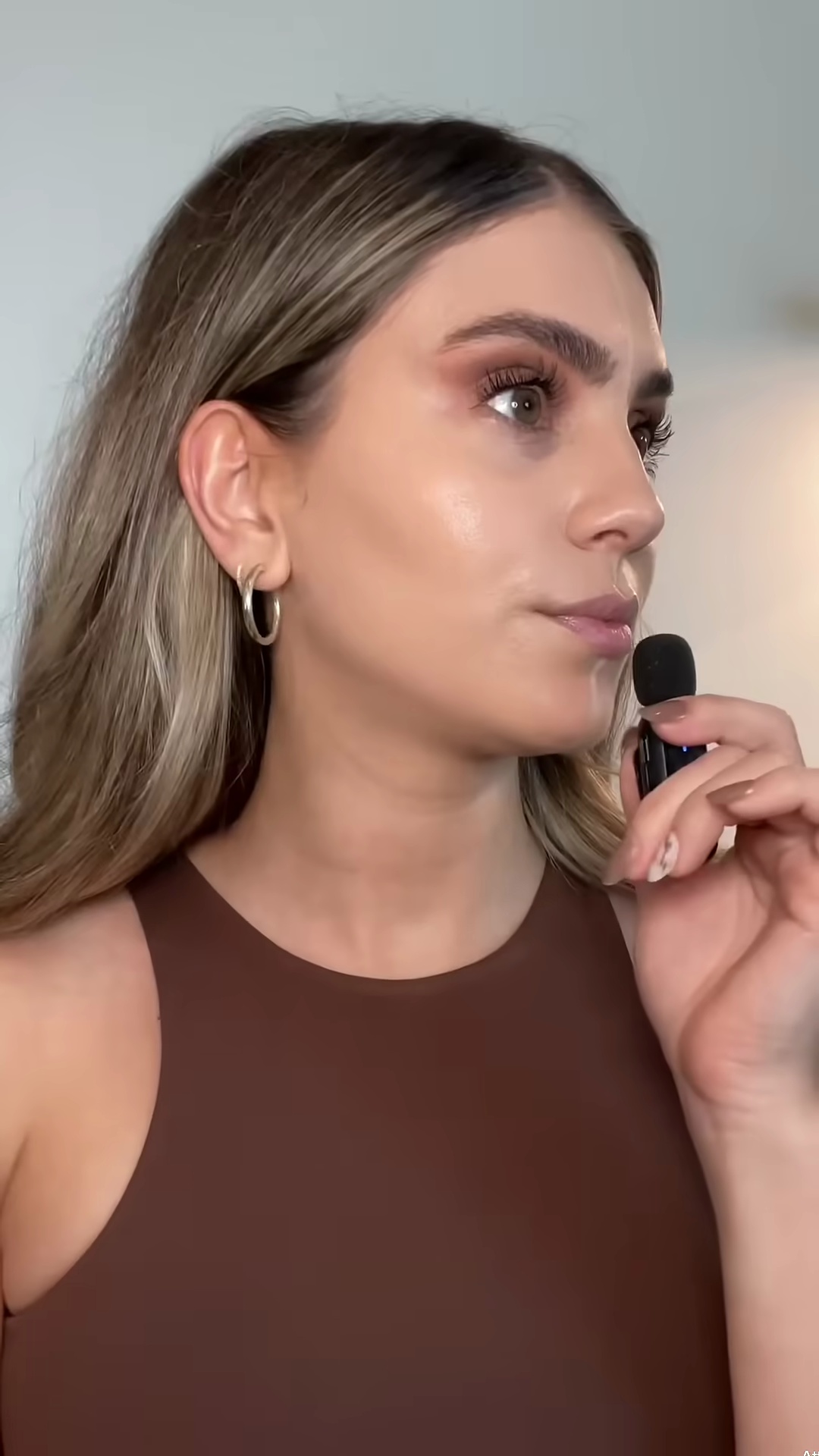 Full body view comparing foundation shades to natural light olive skin tone