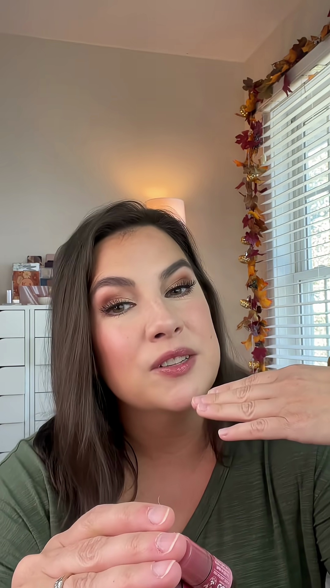 Emily showing the final result of all three tinted lip balms