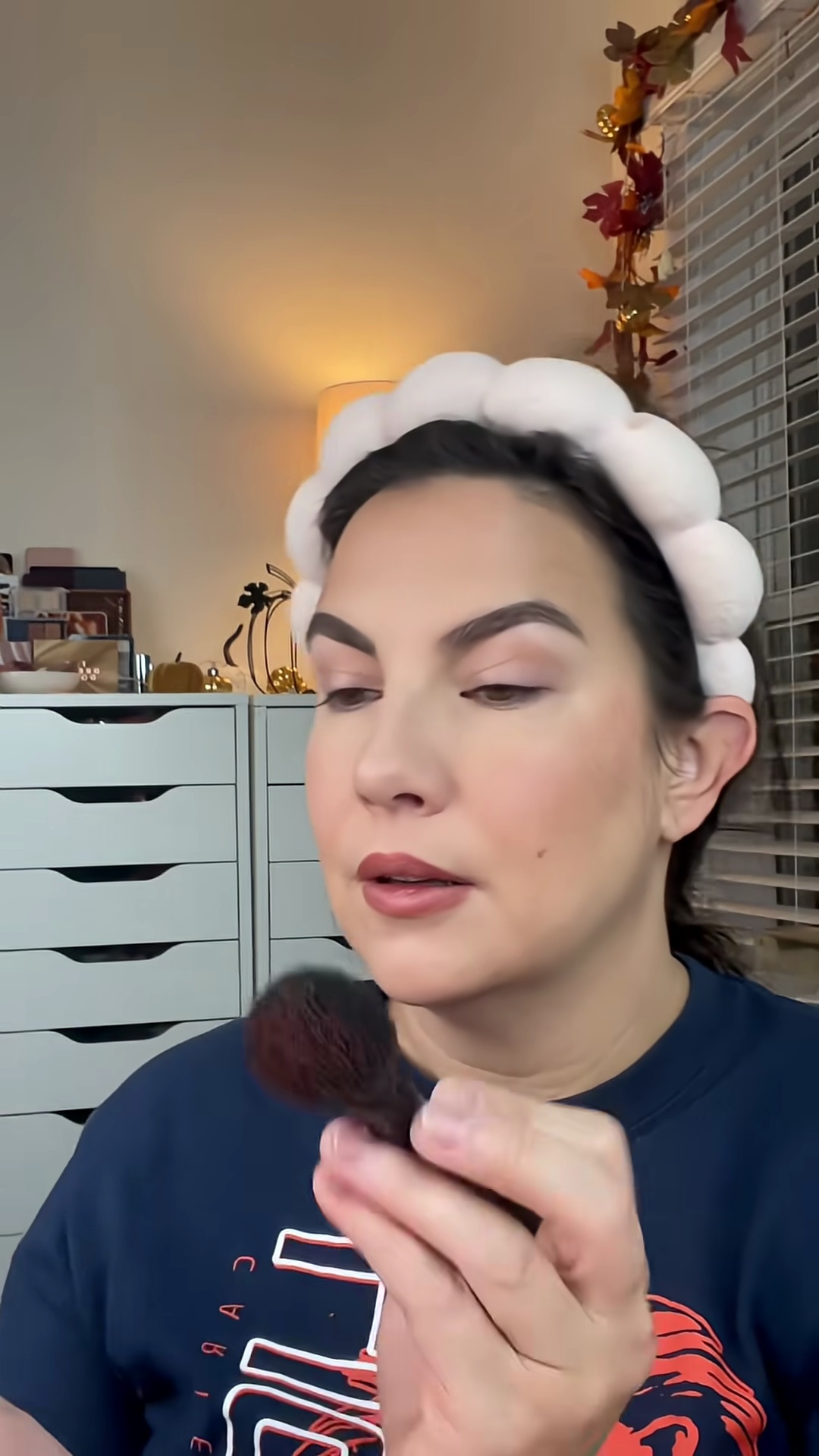 Emily Noel applying berry blush from Krice Cozy Glow palette to cheeks