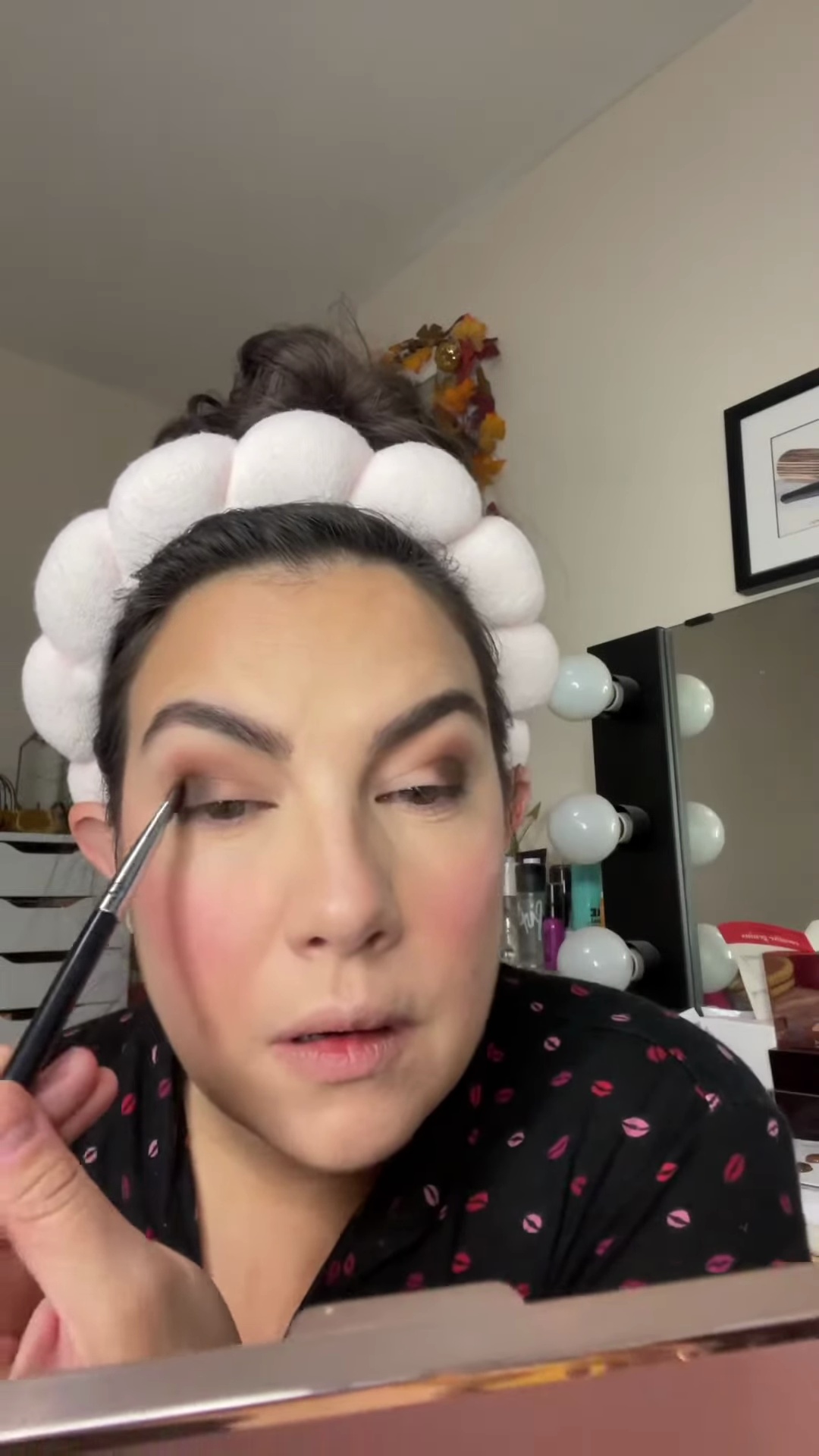 Emily applying dark matte eyeshadow to outer corner with flat brush