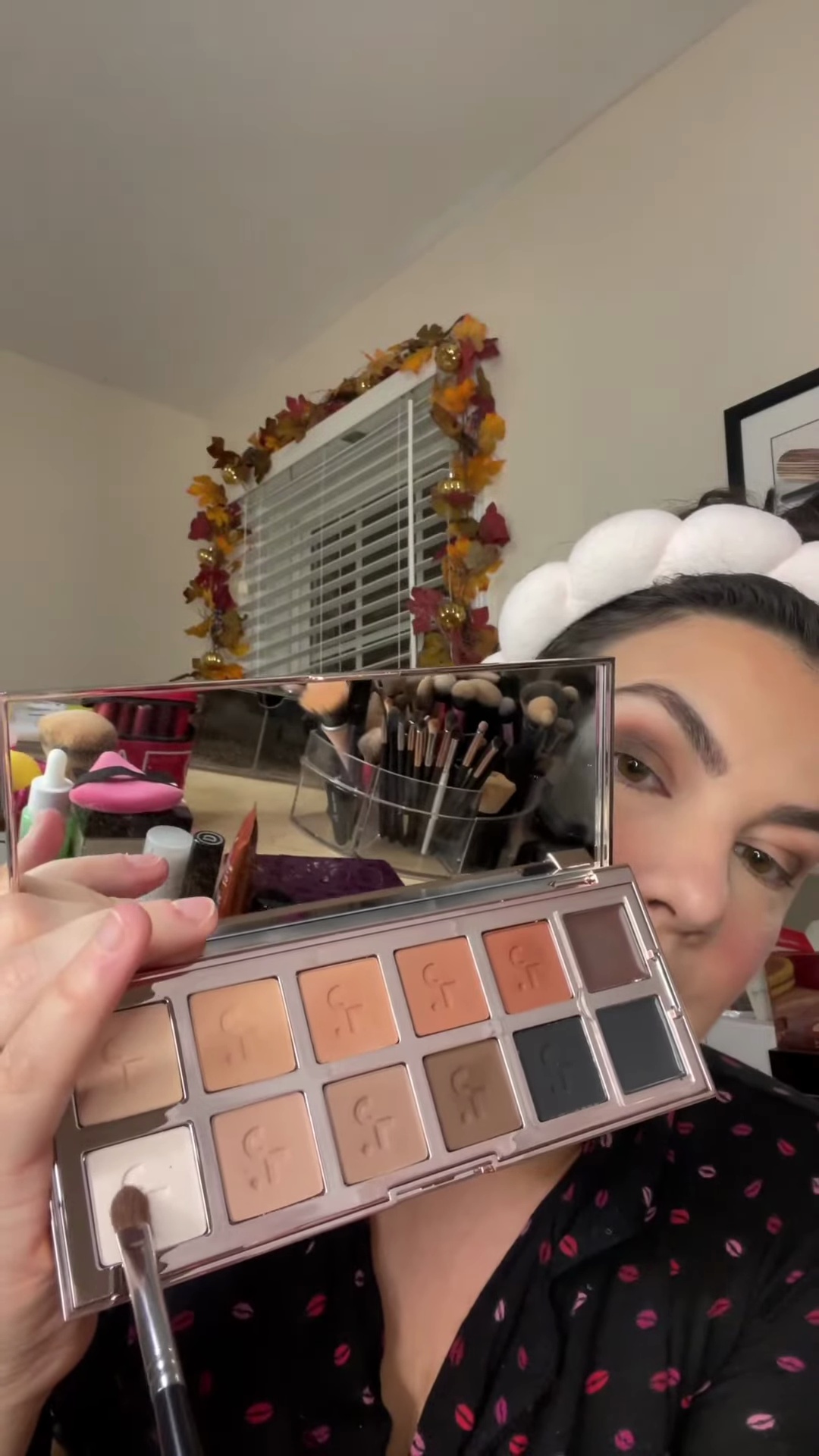 Emily applying bright matte white eyeshadow to inner corner