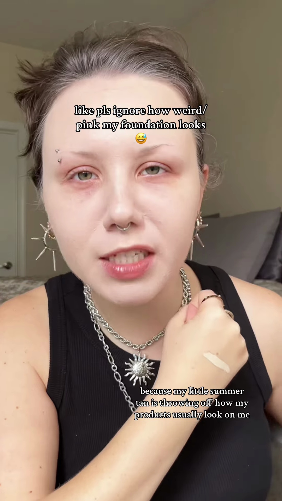 Concealer swatch on olive-toned wrist showing muted grayish undertone