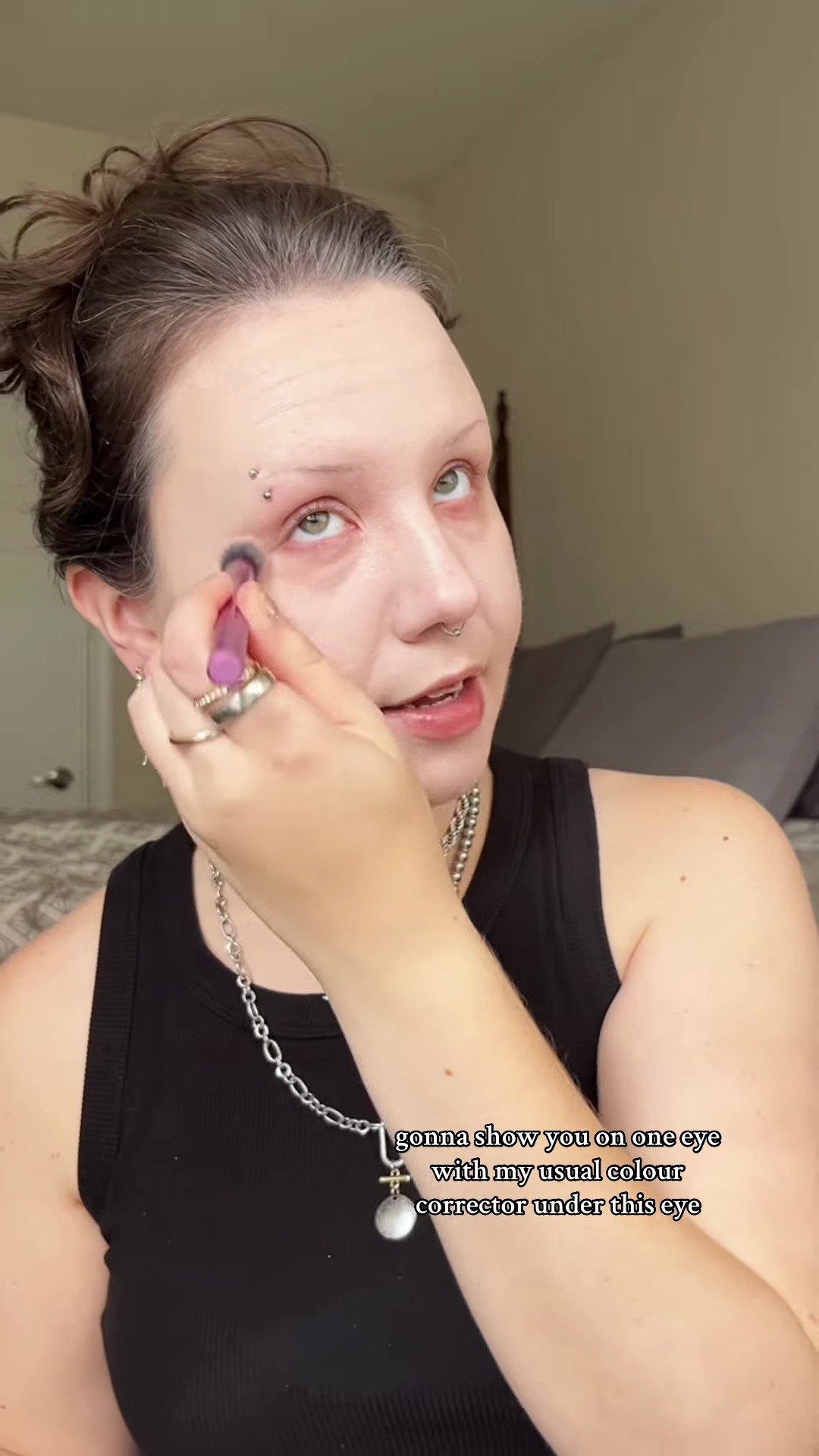 Close-up of concealer being applied and blended under eye area