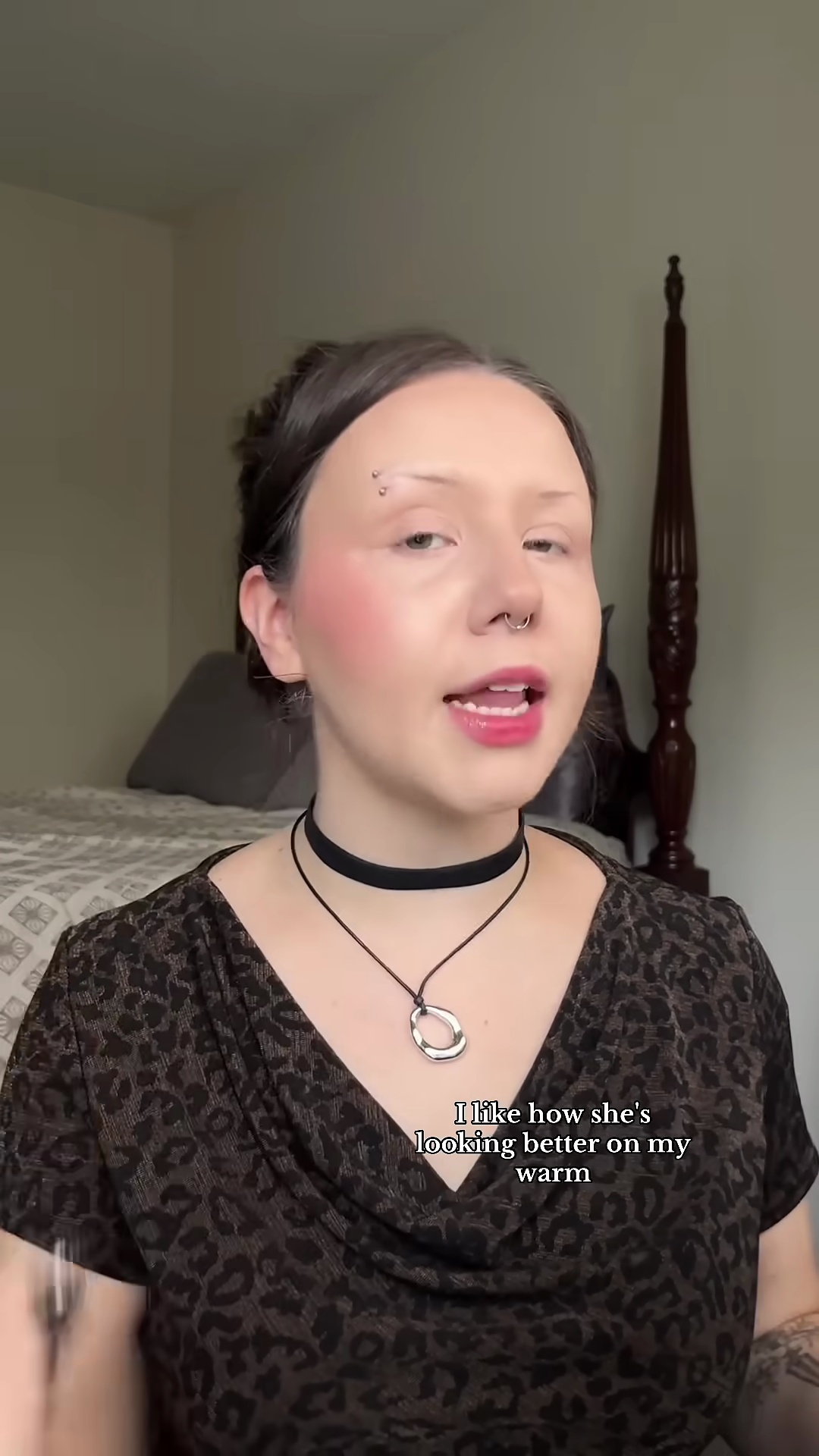 Close-up of red blush application on pale olive skin cheek