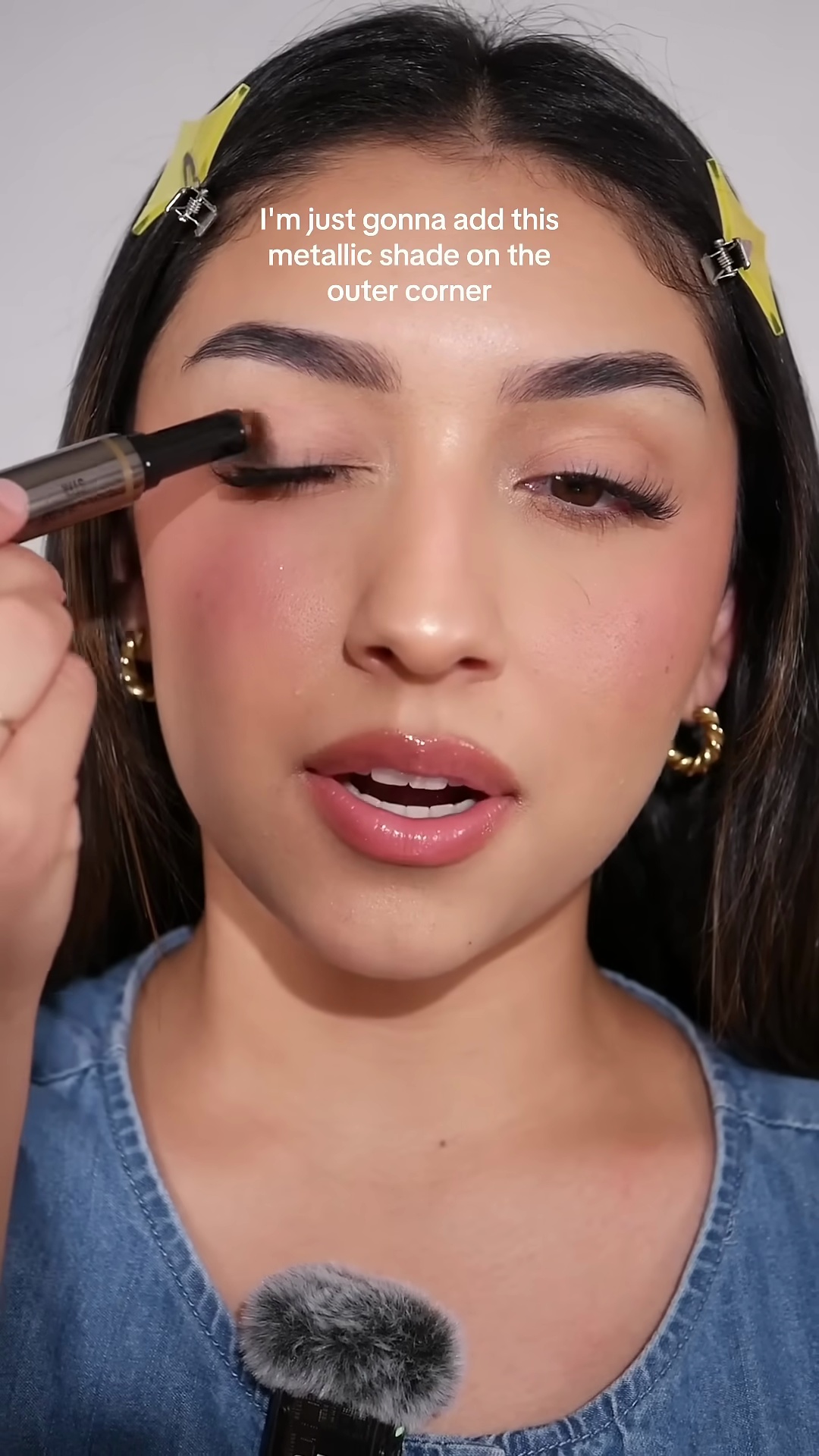 Creator applying Danessa Myricks Colorfix metallic shade to outer eyelid corner with brush